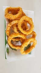 Crunchy Fried Battered onion rings on green plate