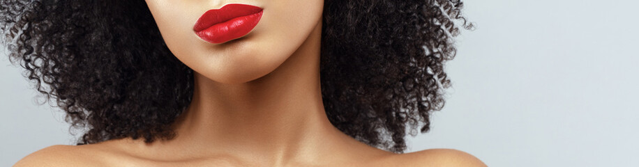 African American woman neckline cropped portrait. Red lips make up. Human body part.