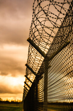 Barbed wire fence on the sunset black and white photography