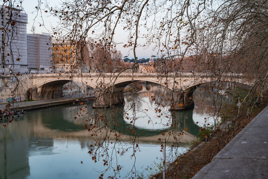 Tranquil Autumn Scene of a Historic Stone Bridge Over Calm Waters