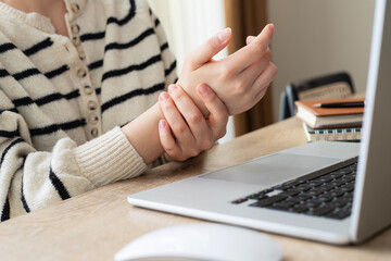 A woman has finger and hand pain after using a computer for a long time. Pain in wrist while using...