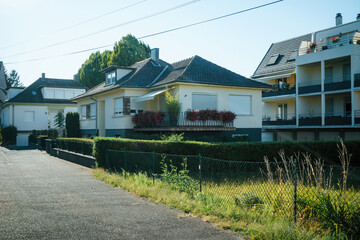 Strasbourg, France - Aug 12, 2022: A bright sunny day on a peaceful suburban street, featuring well-maintained homes and lush landscaping.