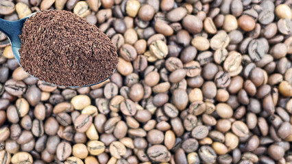 Ground coffee powder in a metal spoon in the foreground, against the background of roasted aromatic coffee beans. Coffee concept.