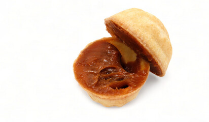 Halves of fresh and tasty cookies in the shape of a walnut with boiled condensed milk on a white background. A favorite delicacy for children and adults with a delicate filling inside.