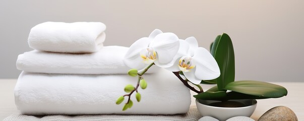 A pile of white towels decorated with beautiful white orchids beside them. generative AI
