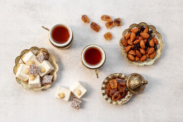 Ramadan party table with tea and sweets. Muslim holiday background