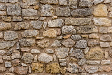Old stone wall with natural stones.