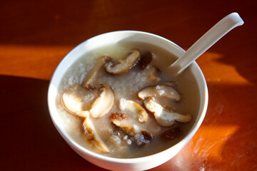 Close-up of chicken rice soup with mushroom in a bowl