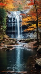 A picturesque waterfall surrounded by autumn foliage, with raindrops creating a shimmering effect on the colorful leaves.