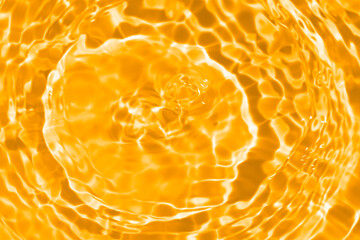 Gold water waves on the surface ripple blurred. Defocus blurred transparent Yellow colored clear...