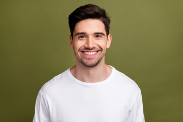 Portrait of cheerful satisfied young man toothy beaming smile good mood isolated on khaki color background