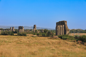 Rome, Italy - 06 27 2023: Aqua Appia that was built to transport water located in green fields. Carved out of the bedrock and the walls of the channel are lined with carved tufa stone