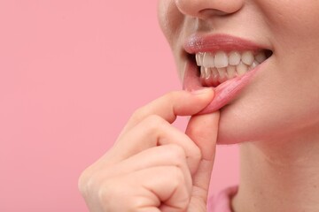 Beautiful woman showing her clean teeth on pink background, closeup. Space for text