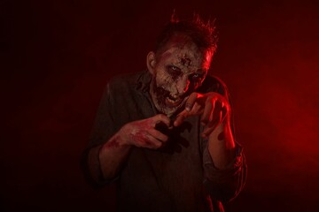 Scary zombie on dark background. Halloween monster