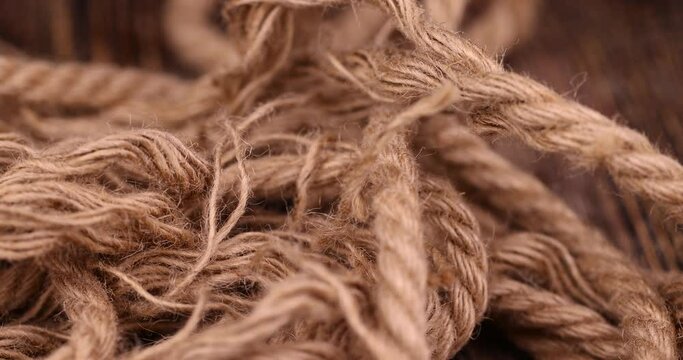 rough linen rope close-up, rough rope on a wooden table