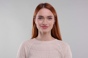 Obraz premium Portrait of happy woman on light grey background