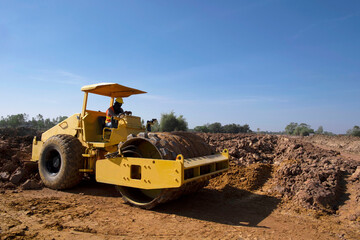 Soil compactor padfoot drum is working. Road roller during highway building