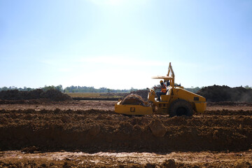 Soil compactor padfoot drum is working. Road roller during highway building