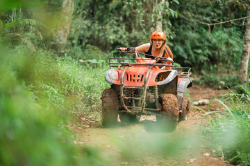 asian woman riding the atv excitedly through the atv arena spending her holiday © Odua Images