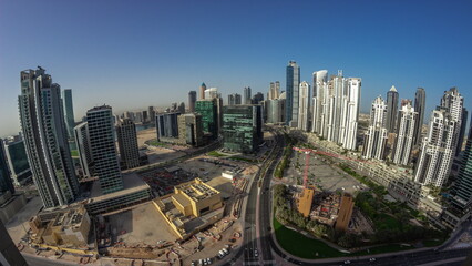Obraz premium Bay Avenue with modern towers residential development in Business Bay aerial panoramic night to day timelapse, Dubai