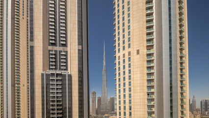 Fototapeta na wymiar Tallest skyscrapers in downtown Dubai located on boulevard street near shopping mall aerial night to day timelapse.