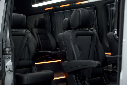Comfortable interior of a passenger bus with soft seats. The design is made to order. Private covering of cars. Various elements of the bus interior.