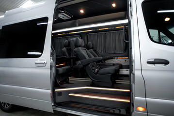 Comfortable interior of a passenger bus with soft seats. The design is made to order. Private...