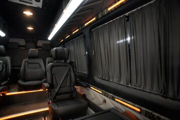 Comfortable interior of a passenger bus with soft seats. The design is made to order. Private...