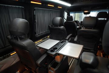 Comfortable interior of a passenger bus with soft seats. The design is made to order. Private covering of cars. Various elements of the bus interior.