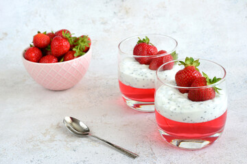 gelatin dessert with strawberry and yogurt in drinking glasses 