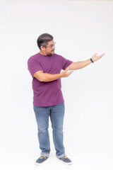 Friendly man in casual attire making a presenting hand gesture to the right, isolated on a white backdrop with copyspace. Full body photo.