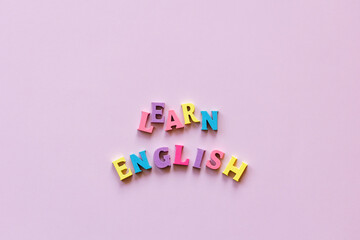 text learn english letters on pink background. Copy space. Language school