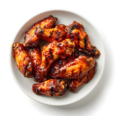 Grilled chicken wings on white bowl top view isolated on white background