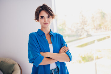 Photo of confident successful woman realtor standing in room showing modern flat