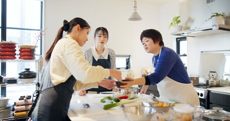 Japan, women and cooking in kitchen with teaching for recipe, Japanese cuisine and healthy meal in...