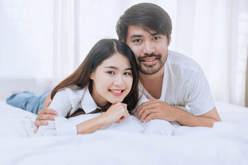 Happy love Asian young man and woman staying together in bedroom, Valentine's Day, Concept of...