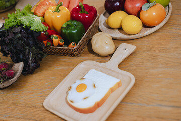 Bread and fried eggs are placed on the kitchen table, Egg on toast that has been placed on top of wood table.