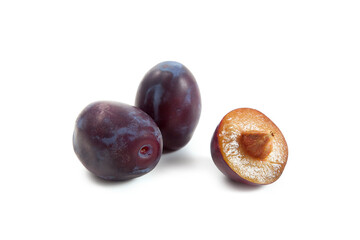 Two Whole and Halves purple plums isolated on white background. .