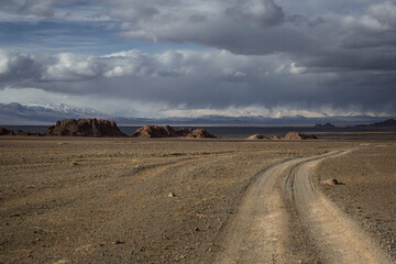 A road in the steppe overlooking the mountains in Mongolia.