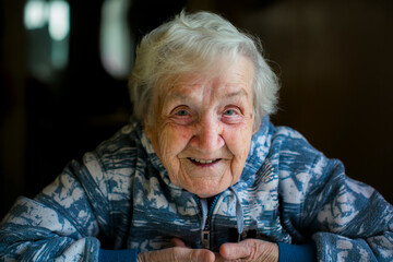 Close-up portrait of an elderly woman in her home. - 718998165