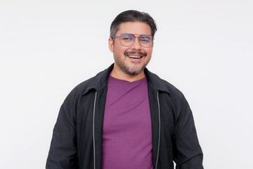 Portrait of a cheerful middle-aged man wearing glasses, a purple shirt, and casual black jacket,...