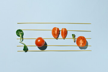 Sheet music of ingredients for a traditional Italian dish, spaghetti and tomato sauce.