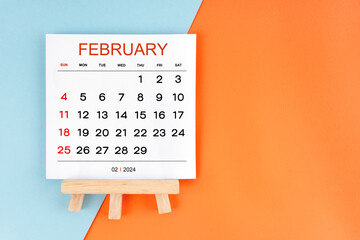 2024 February calendar page on blue and orange background.