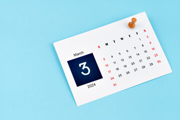 March 2024 calendar page with push pin on blue background.