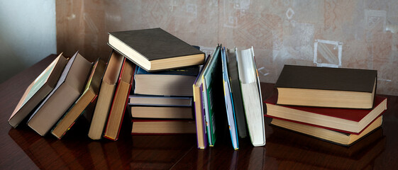 The books are stacked and placed one after another on the table. Concept for education, science,...