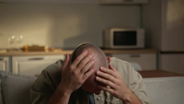 A man examines his balding hair in the mirror. Baldness is linked to your genes and male sex hormones. It usually manifests itself in the form of receding hairlines and thinning of the hair on the top