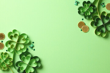 DIY four leaf clover paper art with gold coins on green background. St Patrick's Day holiday...