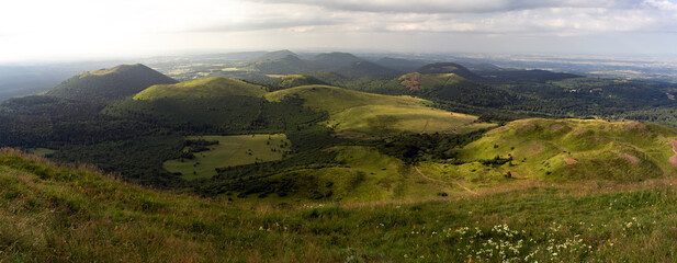 Auvergne vulcan since top of the Puy de Dome vulcan at sunset. Dramatic light landscape. Clermont...