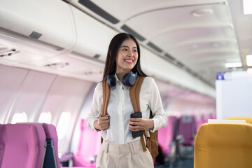 Alone Asian woman passenger traveling by plane. happy traveler on board. Solo travel concept