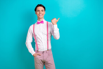Photo portrait of pretty young male point empty space promo poster dressed stylish pink outfit isolated on aquamarine color background
